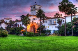 The Santa Barbara Courthouse under a pink sunset with clouds.