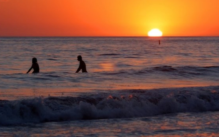 Surfing silhouettes at sunset at Arroyo Burro County Park
